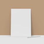 A tall white object stands against a tan wall