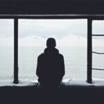 person looking out through window