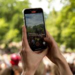 a person taking a picture with a cell phone